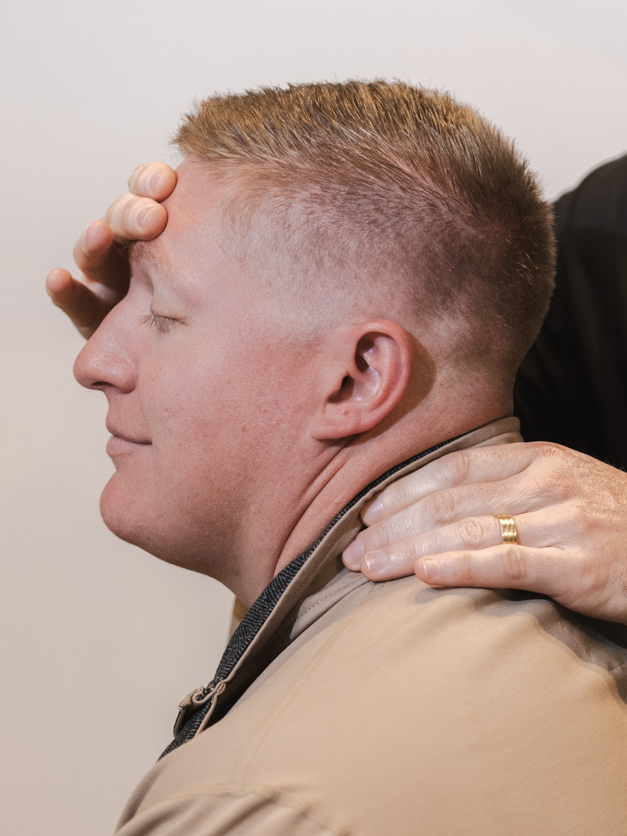 A patient receiving hands-on neck care
